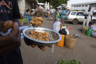 Man with a plate of food at a market