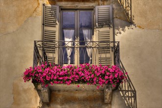 Old balcony with red flowers in Ascona