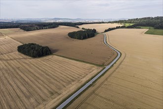 Aerial view of a country road with a red car in Koenigshain in Saxony.