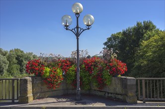 Street lamp and flower boxes on the Neckar bridge with view to the Lauffen barrage in Lauffen am Neckar