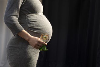 Pregnant woman with wine glass