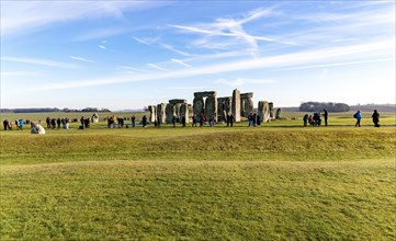 Tourists view standing stones of Neolithic henge