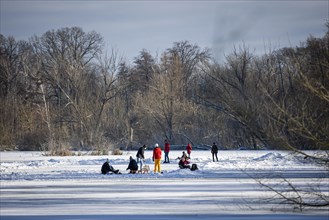 People walk across the ice and skate on the frozen Hermsdorfer See lake in Berlin Reinickendorf. Berlin