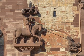 St. George the dragon slayer on the facade of Basel Minster in Basel