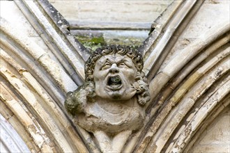 Gargoyle face in stonework of west end of Salisbury cathedral church