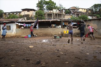 Children play football in Bomeh Village at the KissyRoad dumpsite