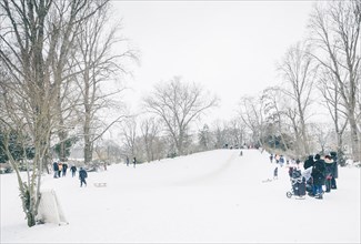 People tobogganing on a small mountain in Kreuzberg in Berlin in the snow. 09.02.2021.