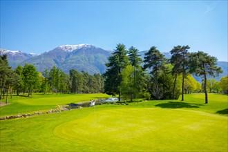 Hole 8 in Golf Club Ascona with Trees and Mountain in Ticino
