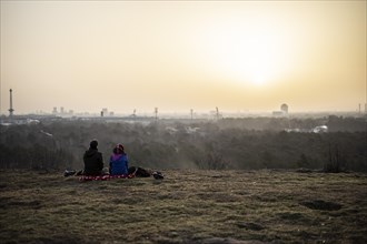 Two people silhouetted against the rising sun in Berlin