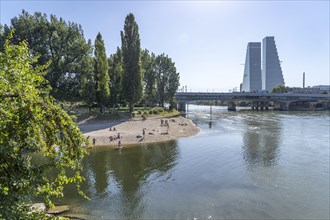 Bathing place on the beach of the Rhine and the Roche Tower in Basel