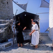 Women baking bread in the traditional communal oven