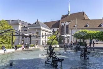 The Fasnacht Fountain or Tinguely Fountain on Theaterplatz and the Elisabethen Church in Basel