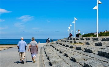 Two people walking along the promenade on the North Sea island of Norderney