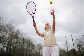Subject: Woman aged 82 standing on the tennis court