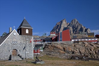 Uummannaq village with colourful houses and church in front of Heart Mountain
