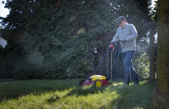 Subject: Man tends his lawn.