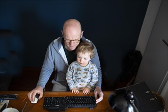 Man in home office and a small child