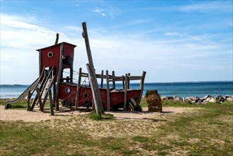 Climbing frame in the shape of a ship on a playground on the beach