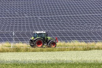 Tractor in front of solar field