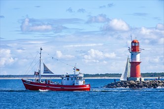 The fishing vessel PASEWALK leaves the harbour entrance with passengers and with a hoisted pirate flag towards the open sea