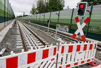 Symbolic photo on the subject of railway infrastructure. A barrier of a construction site stands on a newly built track at Lichtenrade station. Berlin