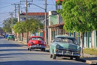 Classic American cars parked along street in the town Ranchuelo in the Villa Clara Province on the island Cuba