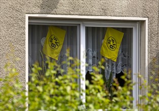 Flags of Borussia Dortmund in the window of a residential building