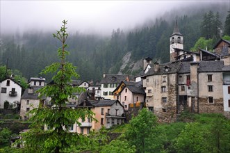 Small Village Fusio in the Mountain with Green Trees and Clouds in Ticino