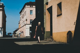 Woman with handbag on the street of the small town