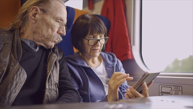 Elderly couple travel by train