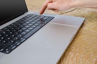 Closeup view of finger ready to press enter key on laptop