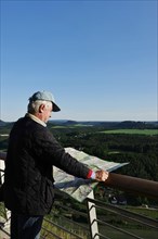 Man visiting the Elbe Sandstone Mountains with map