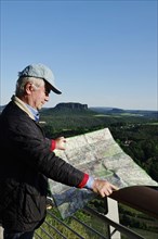 Man visiting the Elbe Sandstone Mountains with map