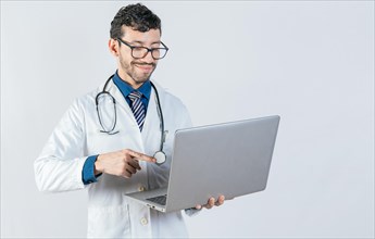 Young doctor in glasses using notebook on isolated background