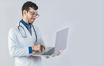 Handsome doctor using laptop isolated