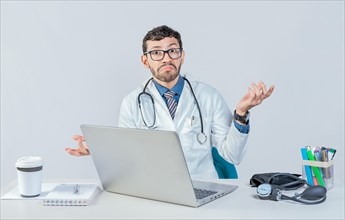 Doctor with laptop with confused expression