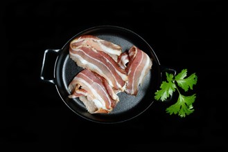 Bacon strips in pans