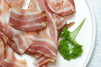 Bacon strips on plate with parsley