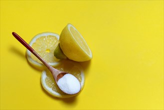 Citric acid in wooden spoon and lemon