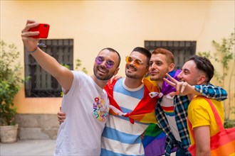 Homosexual male friends having fun at gay pride party taking a selfie