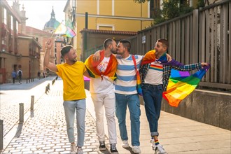 Couples of men having fun and kissing at the demonstration with the rainbow flags