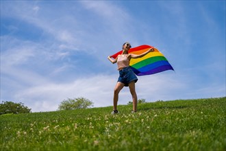 Caucasian brunette woman with a rainbow lgbt flag