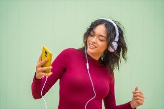Portrait of latin woman with headphones smiling