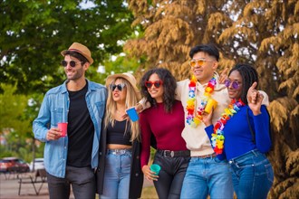 Group portrait of multi ethnic friends having a party in a park