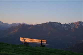 Viewpoint or bench in the sunrise with a view of the mountains of the Bavarian Alps and the Karwendel