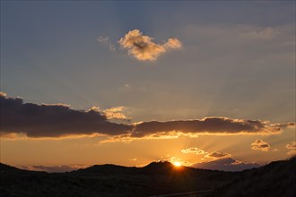 Sunset behind dunes