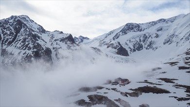 The Taschachhaus in the Ötztal Alps with morning fog in spring