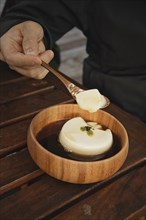A spoon holding delicious tofu pudding