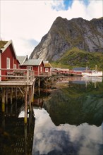 Traditional red rorbuer cabins in the fishing village of Reine