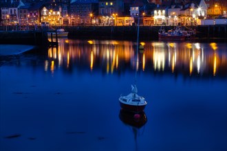 Small boat in the evening in the harbour of Whitby